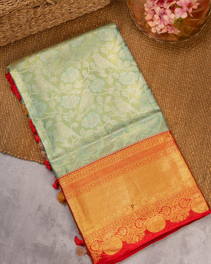 Exclusive Tissue Kanchipuram in Pastel Green with all over Parrots weaving and Red Borders & Hand Embroidered Blouse | Blouse Size 38-44” | Free Shipping