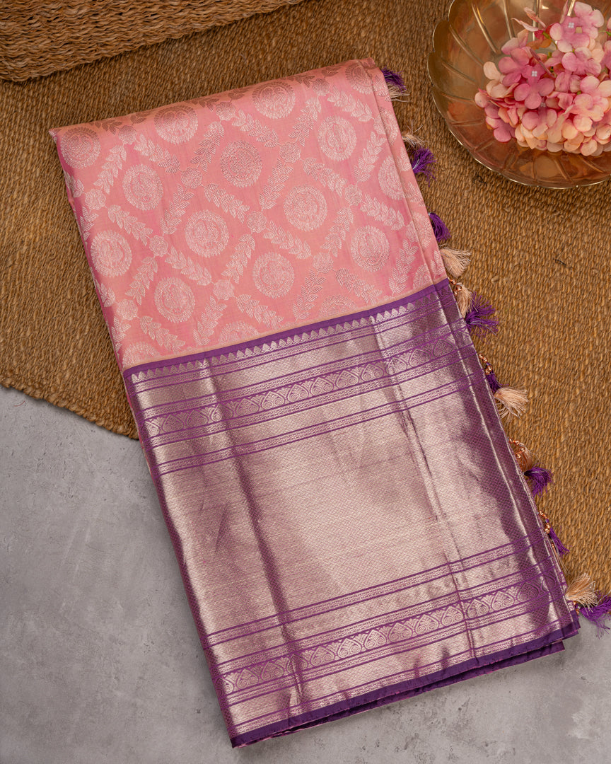Pastel Peach Kanchipuram Silk Saree with all over Jangla Weaving and Silver borders & Elegant Hand work Purple Blouse