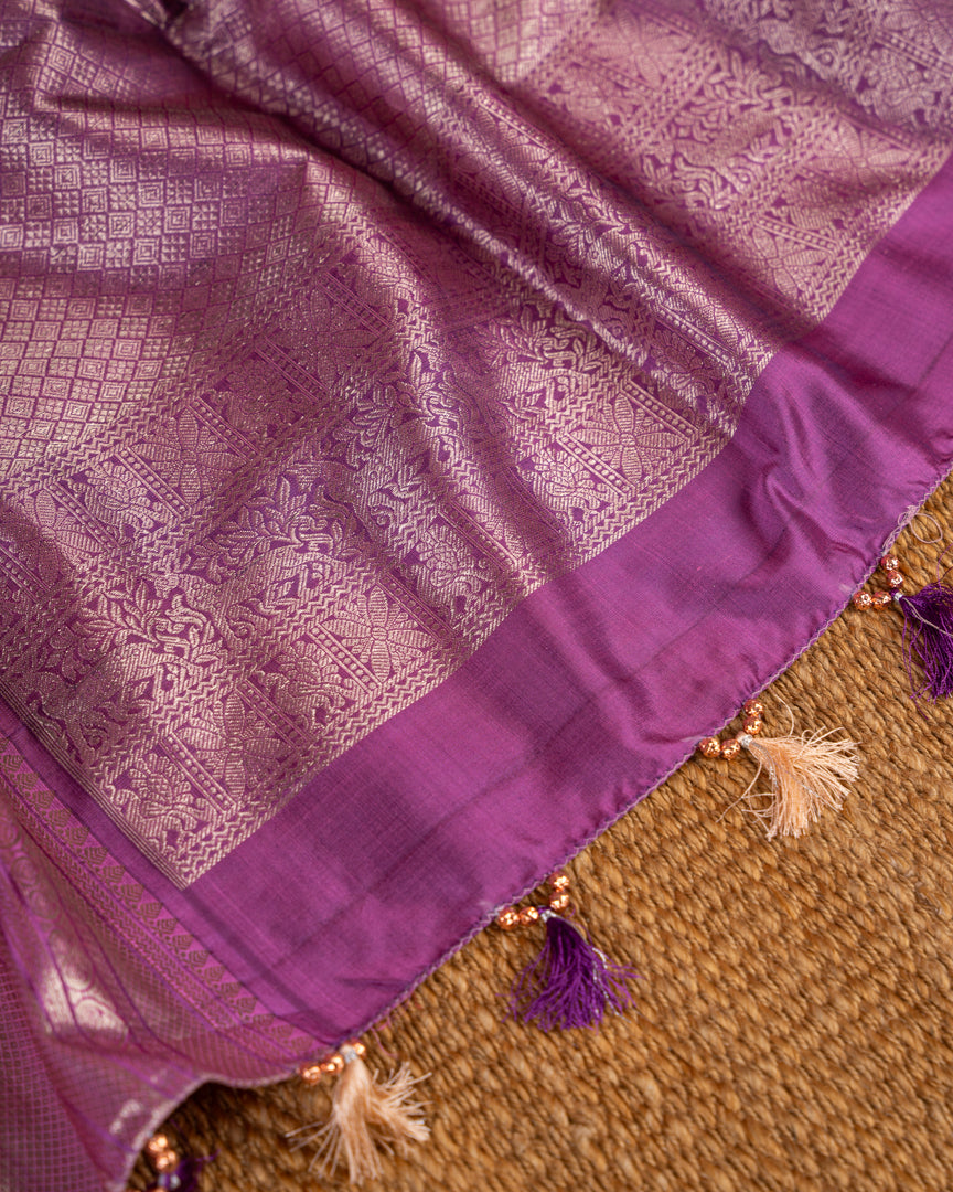 Pastel Peach Kanchipuram Silk Saree with all over Jangla Weaving and Silver borders & Elegant Hand work Purple Blouse